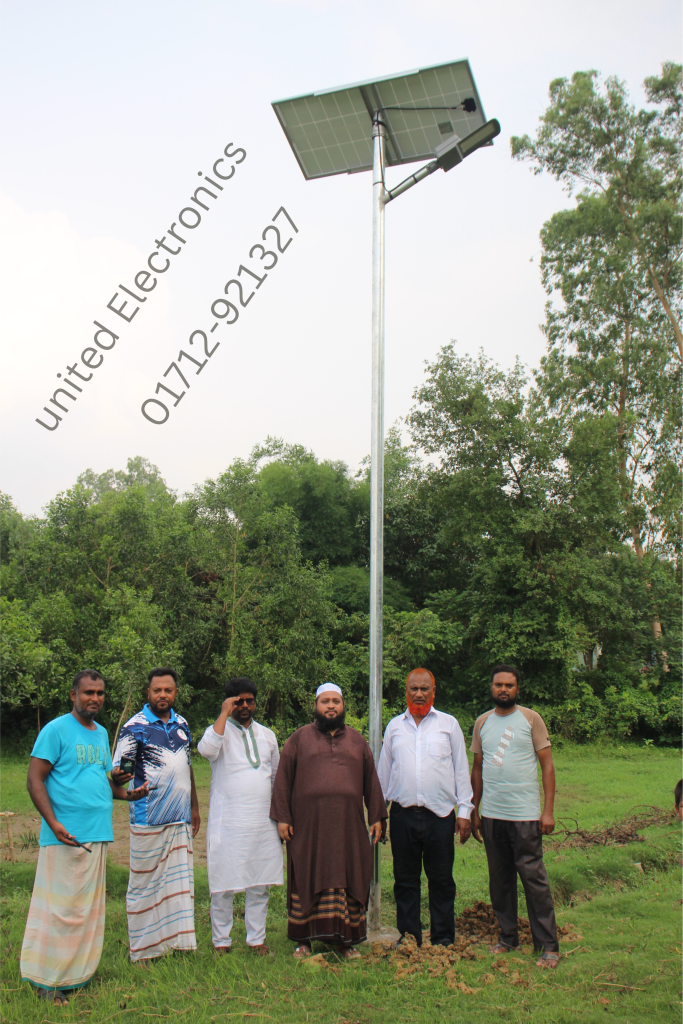 Group beside an installed solar street light and panel
